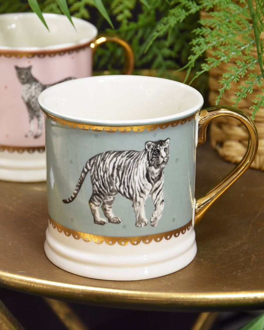 A teal tankard mug with a vivid tiger stripe pattern wraps around the exterior, paired with a sturdy, comfortable handle for a bold kitchen statement.