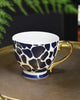 Vibrant teal mug with a chic giraffe pattern and a luxurious gold handle, radiating elegance for a sophisticated tea or coffee experience.