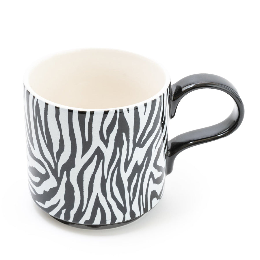 Elegant zebra-striped mug with a glossy finish and contrasting black handle, set against a white background for a modern kitchenware look