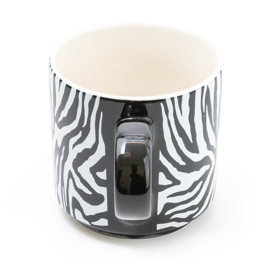Elegant zebra-striped mug with a glossy finish and contrasting black handle, set against a white background for a modern kitchenware look
