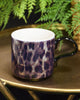 Stylish leopard print ceramic mug with a sleek handle, showcasing a vibrant pattern of black and brown spots