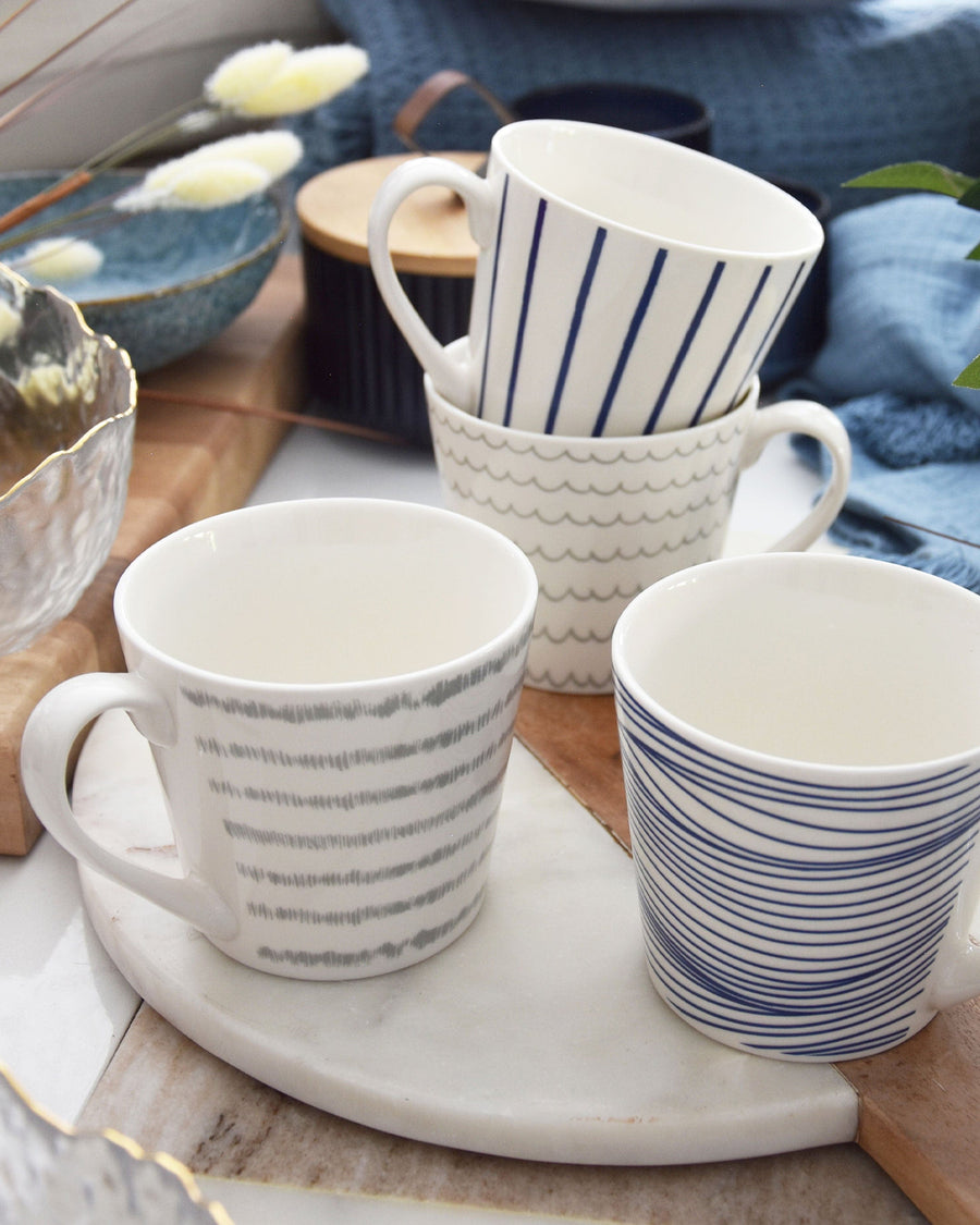 Wide mug with a serene nautical theme, featuring subtle grey dashes that mimic gentle ocean waves, against a classic white background suitable for a cozy, maritime-inspired kitchen.
