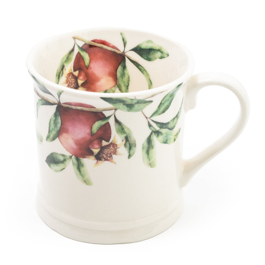 Sturdy tankard mug with a vivid illustration of a pomegranate tree, featuring deep red pomegranate fruits set against lush green leaves, all on a glossy white background.