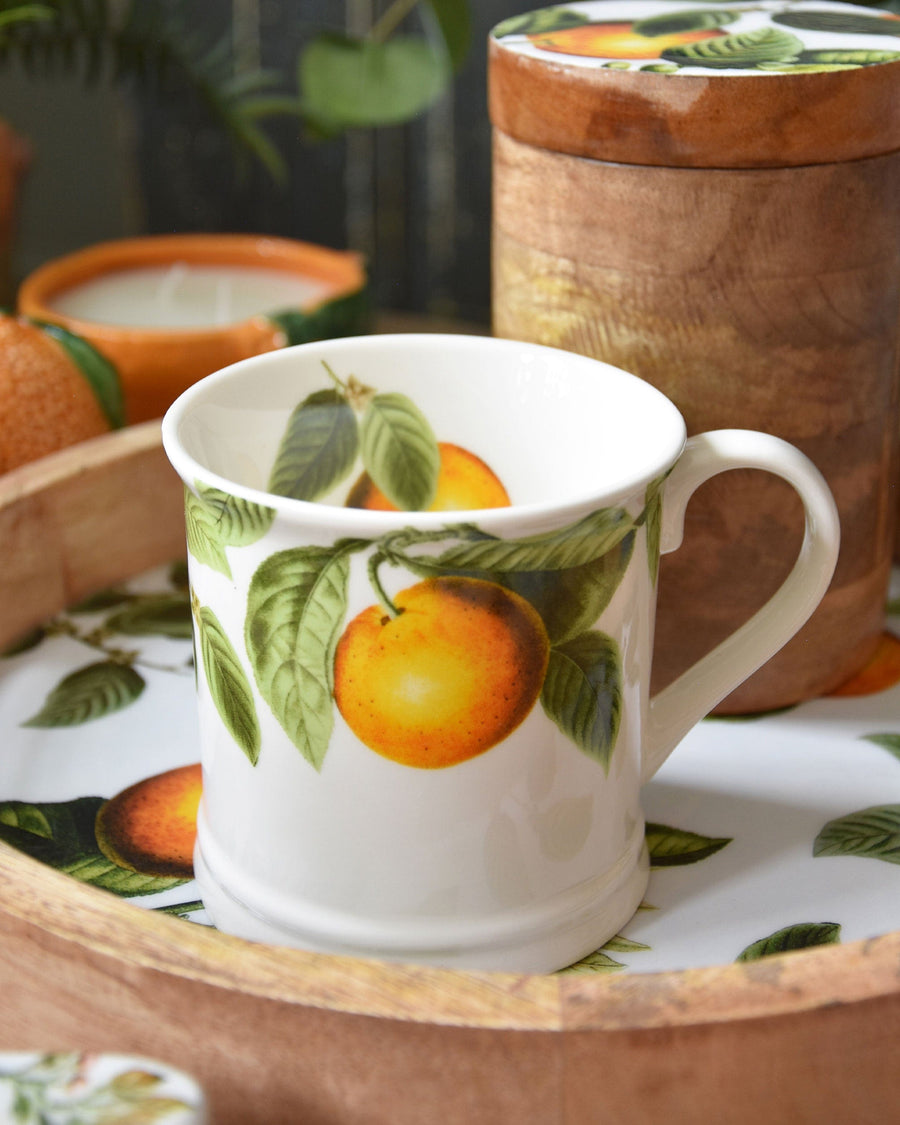 Image of a White Tankard Mug with a detailed, vibrant orange tree illustration on the side, set against a soft-focus background that enhances the mug's orchard-inspired design.